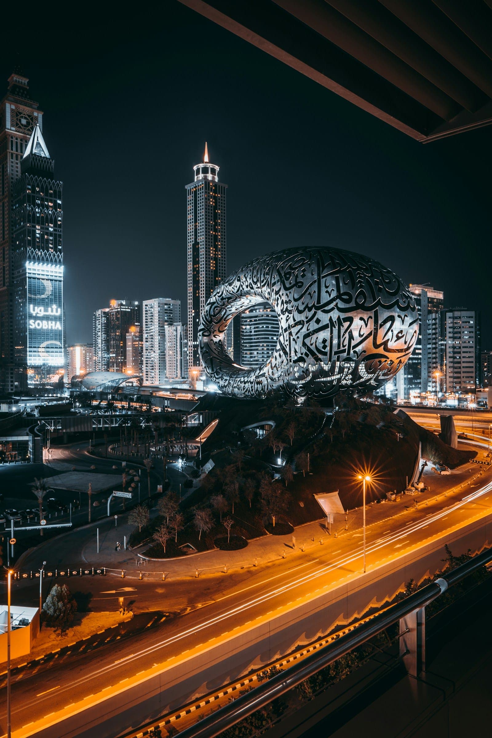 The Museum of the Future in Dubai at night, its facade written in Arabic calligraphy