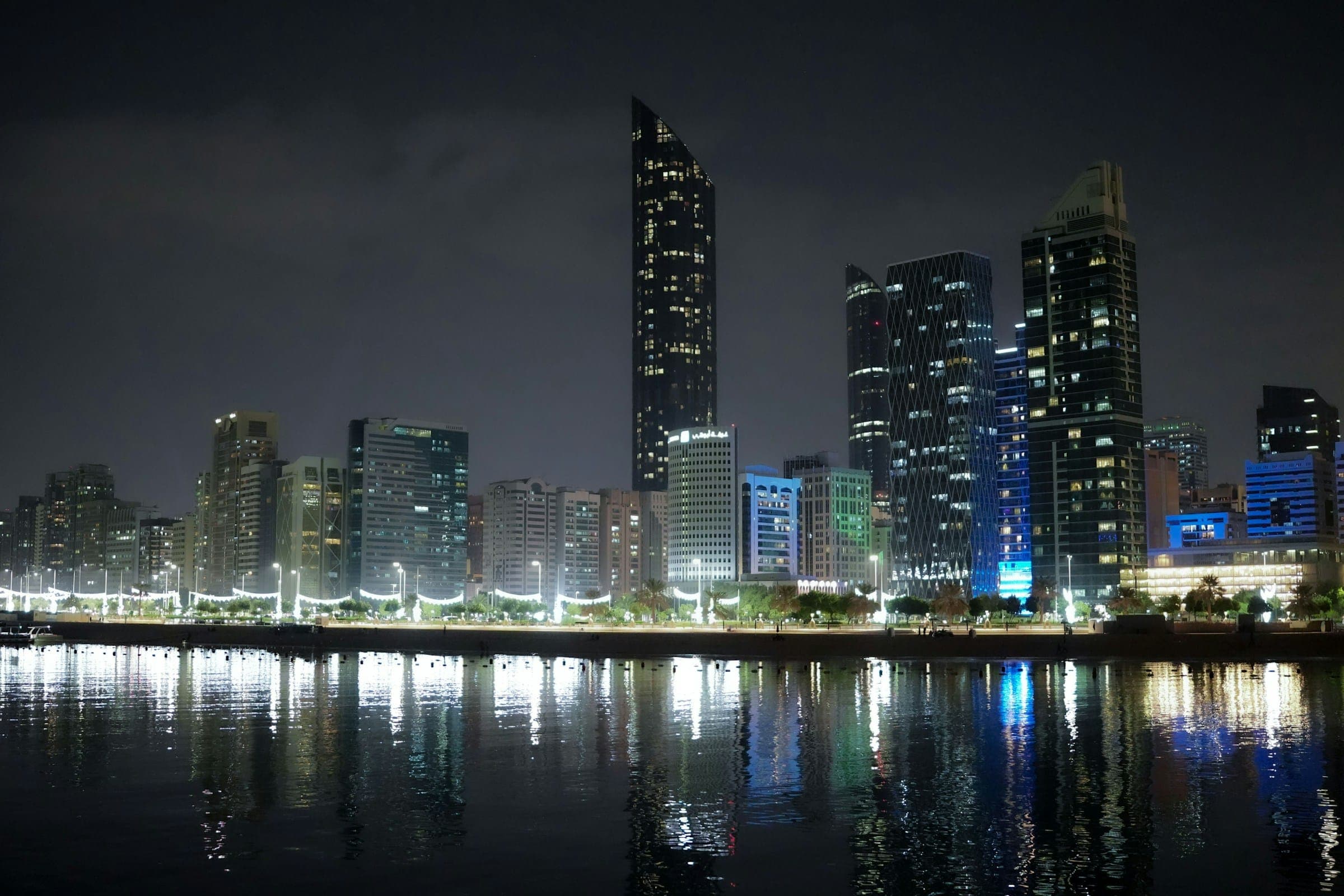 City towers reflected in the water at night